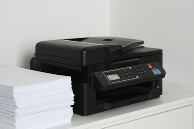 Photo of Modern printer and paper sheets on white table indoors