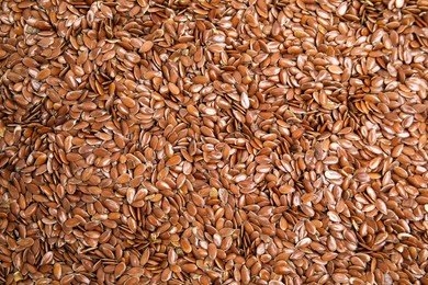 Heap of flax seeds as background, top view. Veggie food