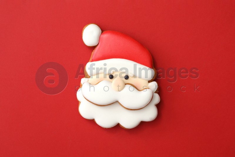 Christmas Santa Claus shaped gingerbread cookie on red background, top view