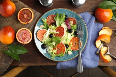 Delicious sicilian orange salad served on wooden table, flat lay