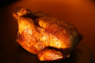 Delicious grilled whole chicken on black table, closeup