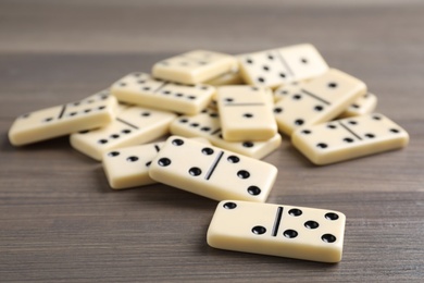 Pile of domino tiles on wooden table