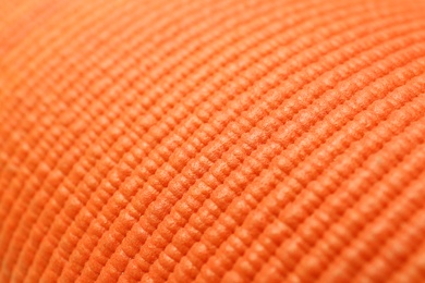 Orange foam rubber mat as background, closeup view