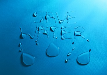 Photo of Inscription Save Water made of drops on light blue background