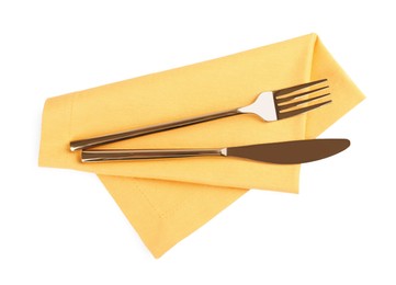 Photo of Yellow napkin with golden fork and knife on white background, top view