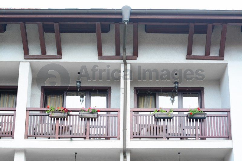Photo of Exterior of beautiful residential building with balconies and flowers