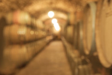 Blurred view of wine cellar with large wooden barrels