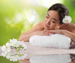 Image of Beautiful Asian woman lying on massage table. Spa treatment