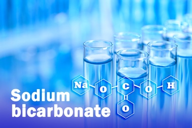 Text Sodium bicarbonate with soda formula and test tubes on background