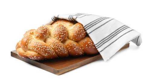 Homemade braided bread with sesame seeds and napkin isolated on white. Traditional Shabbat challah
