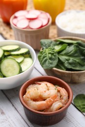 Photo of Ingredients for poke bowl on white wooden table