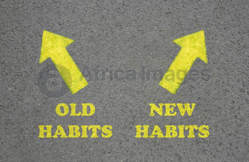 Arrows with two opposite directions to Old and New Habits on asphalt, top view