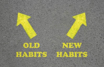 Arrows with two opposite directions to Old and New Habits on asphalt, top view