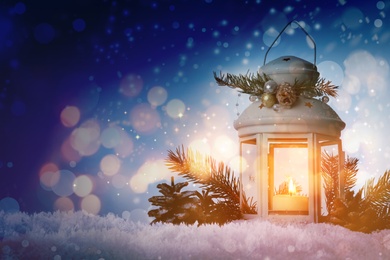 Composition with Christmas lantern on snow, space for text. Magical atmosphere 