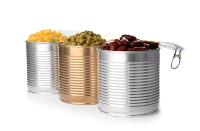 Tin cans with conserved vegetables on white background