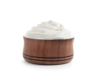 Wooden bowl with fresh sour cream isolated on white