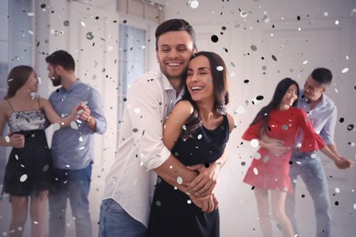 Image of Lovely young couple dancing together at party