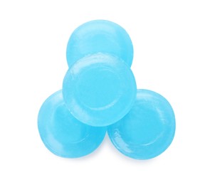 Many light blue cough drops on white background, top view