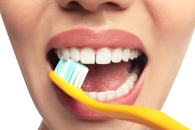 Woman brushing teeth on white background, closeup. Dental care