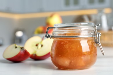 Delicious apple jam and fresh fruits on white table, closeup