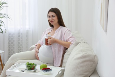 Photo of Pregnant woman eating breakfast at home. Healthy diet