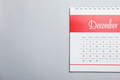 December calendar on light grey background, top view. Space for text