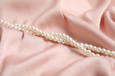 Beautiful white pearls on delicate pink silk
