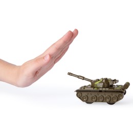 Woman showing stopping sign in front of toy tank on white background. No war concept