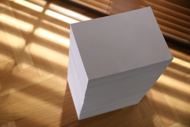 Photo of Stack of paper sheets on wooden table, above view