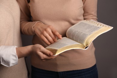 Women reading Bible together, closeup. Religious literature