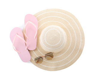 Photo of Pink flip flops, hat and sunglasses on white background, top view. Beach objects