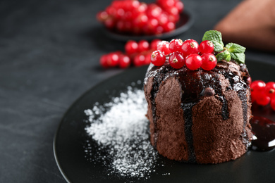 Photo of Delicious warm chocolate lava cake with mint and berries on table, closeup. Space for text
