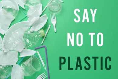 Text SAY NO TO PLASTIC and disposable items on green background, flat lay