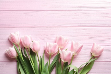 Beautiful tulips for Mother's Day on wooden background, top view