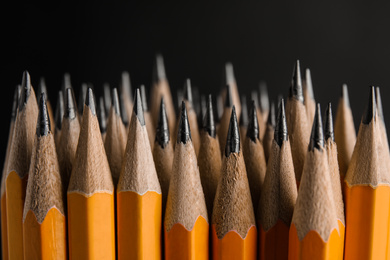 Many graphite pencils on black background, closeup