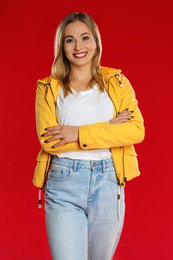 Photo of Beautiful woman in casual outfit on red background