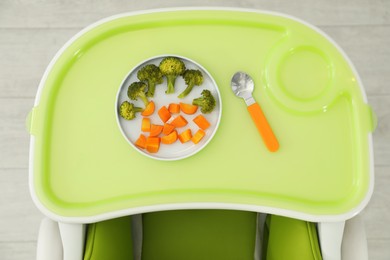 Baby high chair with healthy food, top view