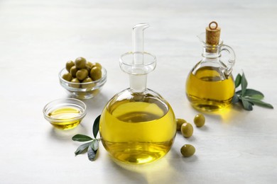Bottle of fresh olive oil on white table