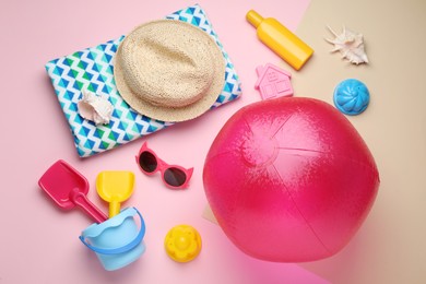 Flat lay composition with beach ball, sand toys and accessories on color background