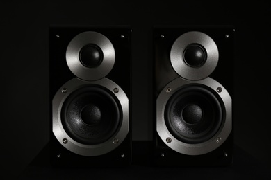Modern powerful audio speakers on black background