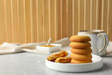 Tasty shortbread cookies with filling on light grey marble table