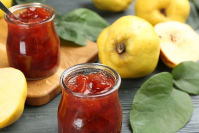 Photo of Delicious quince jam on grey table, closeup