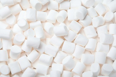 Delicious white puffy marshmallows as background, top view