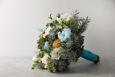 Beautiful wedding winter bouquet on grey table. Space for text