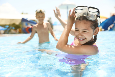 Little children having fun in swimming pool. Summer vacation