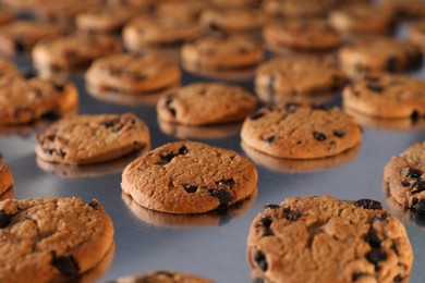 Photo of Many delicious cookies on production line, closeup
