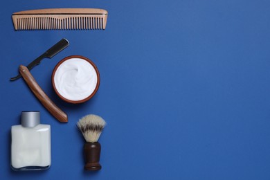 Flat lay composition with men's shaving accessories on blue background, space for text