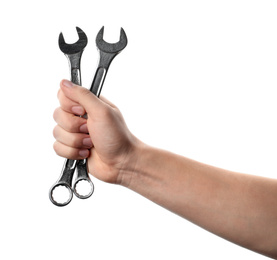 Photo of Auto mechanic holding wrenches isolated on white, closeup