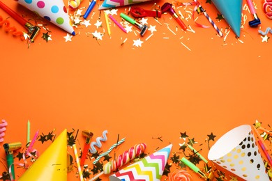 Photo of Beautiful flat lay composition with festive items on orange background, space for text. Surprise party concept