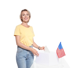 Woman putting ballot paper into box against white background